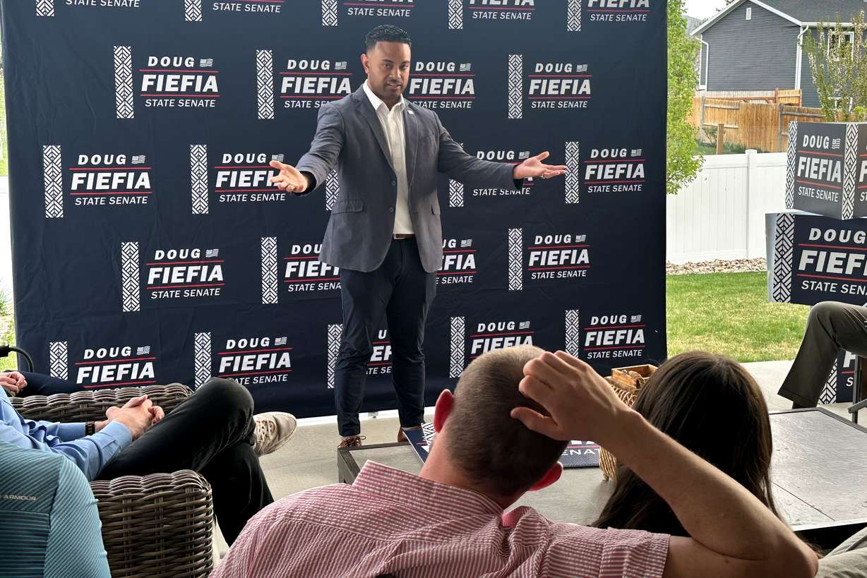 Rep. Doug Fiefia, R-Herriman, talks to voters on the back deck of a house, April 9, in Riverton. Fiefia is challenging Sen. Dan McCay, R-Riverton, for a state Senate seat.