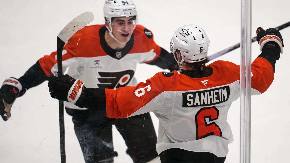 Philadelphia Flyers' Travis Sanheim (6) celebrates with Porter Martone (94) after scoring during the third period of Game 1 in the first round of the NHL Stanley Cup playoffs against the Pittsburgh Penguins in Pittsburgh, Saturday, April 18, 2026.