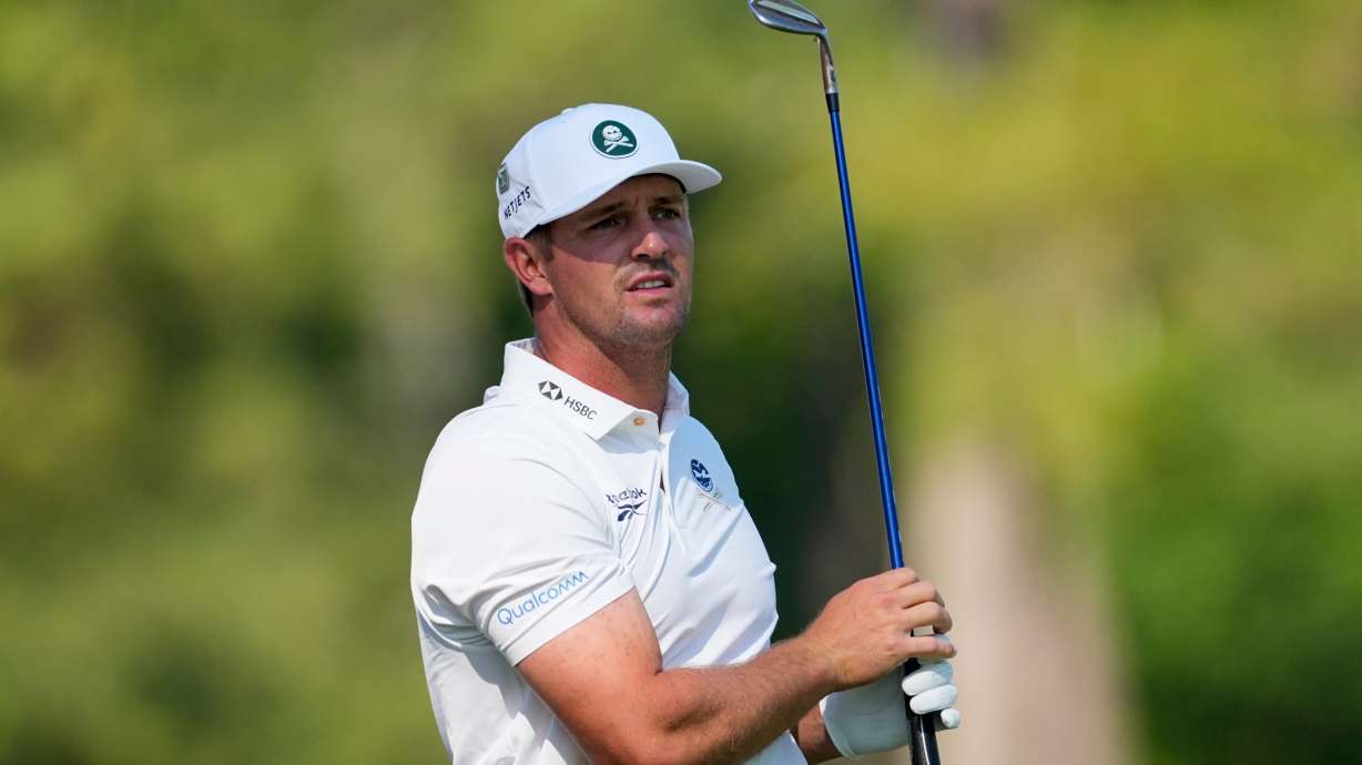 Bryson DeChambeau watches his tee shot on the 12th hole during the second round of the Masters golf tournament at the Augusta National Golf Club, Friday, April 10, 2026, in Augusta, Ga.