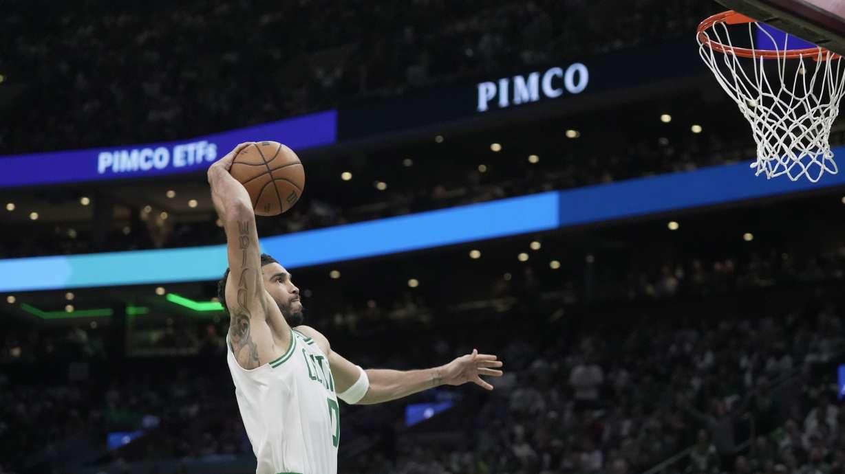 Boston Celtics forward Jayson Tatum goes in for a dunk against the Philadelphia 76ers during the first half in Game 1 of a first-round NBA playoffs basketball game, Sunday, April 19, 2026, in Boston.