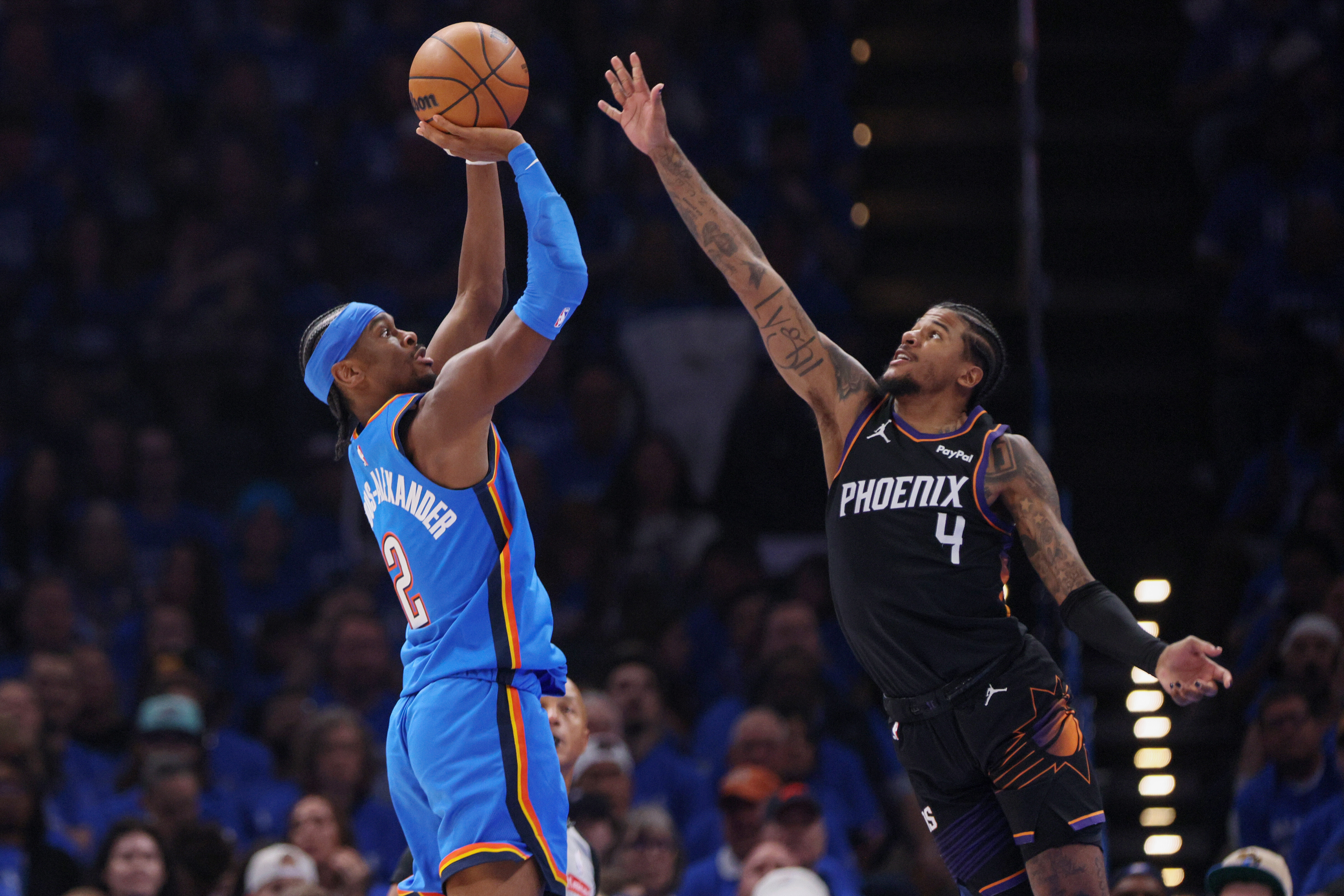 Oklahoma City Thunder guard Shai Gilgeous-Alexander (2) looks to shoot over Phoenix Suns guard Jalen Green (4) during the first half in Game 1 of a first-round NBA playoffs basketball series Sunday, April 19, 2026, in Oklahoma City. 