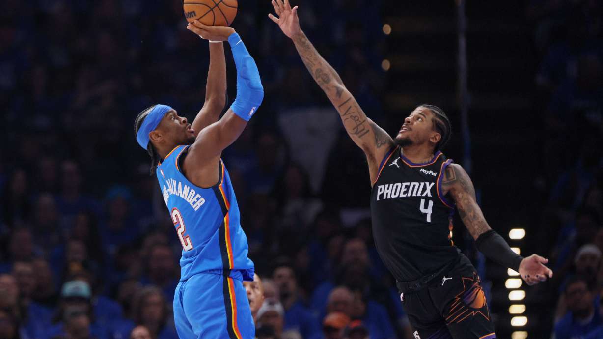 Oklahoma City Thunder guard Shai Gilgeous-Alexander (2) looks to shoot over Phoenix Suns guard Jalen Green (4) during the first half in Game 1 of a first-round NBA playoffs basketball series Sunday, April 19, 2026, in Oklahoma City.