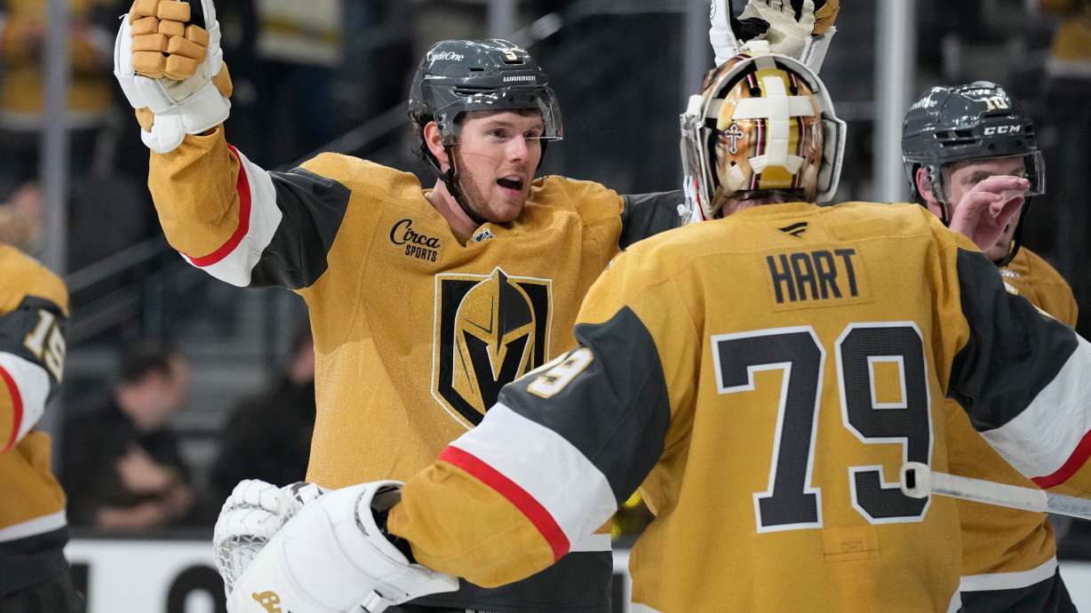 Vegas Golden Knights defenseman Jeremy Lauzon, left, celebrates with Vegas Golden Knights goaltender Carter Hart (79) after defeating the Utah Mammoth in Game 1 of a first-round NHL hockey Stanley Cup playoff series Sunday, April 19, 2026, in Las Vegas.