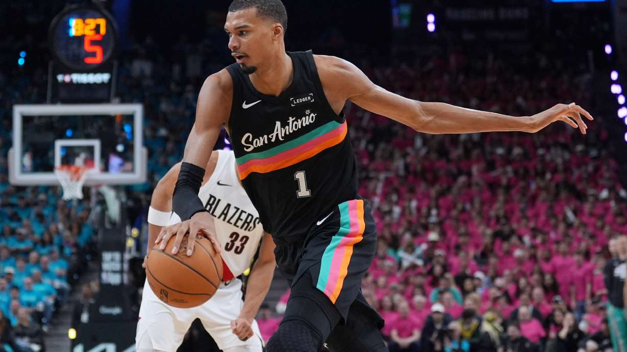 San Antonio Spurs forward Victor Wembanyama (1) drives past Portland Trail Blazers forward Toumani Camara (33) during the second half in Game 1 of a first-round NBA playoffs basketball series in San Antonio, Sunday, April 19, 2026.