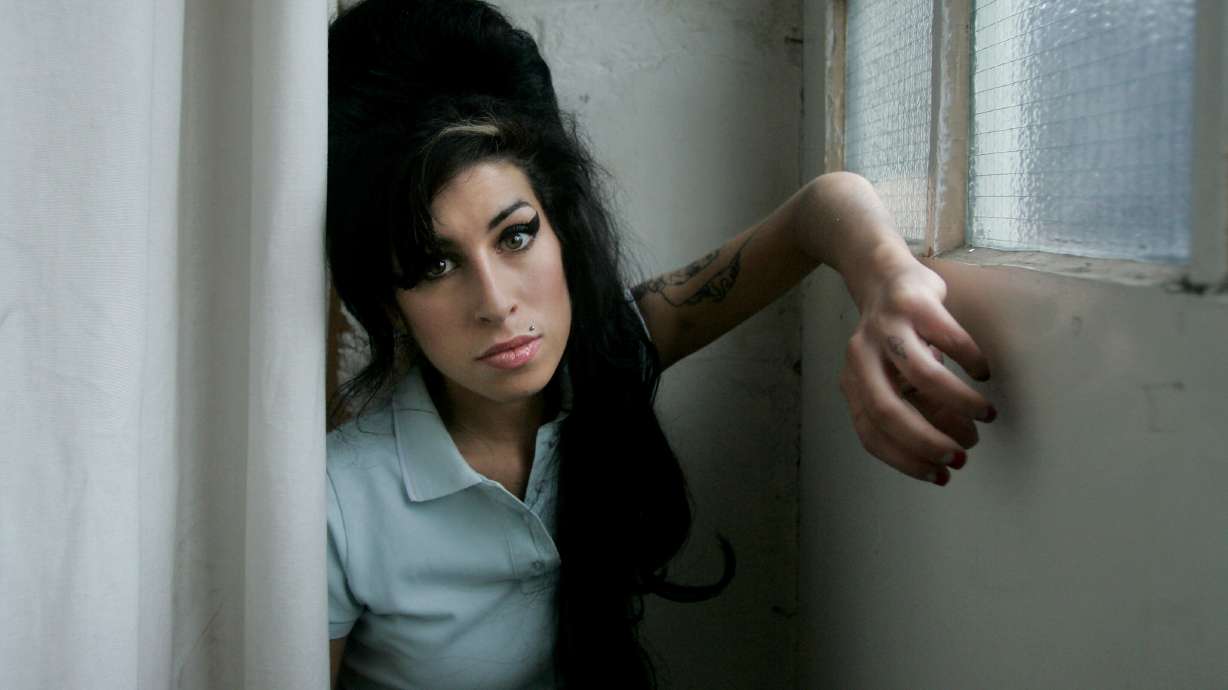 British singer Amy Winehouse poses for photographs after being interviewed by the Associated Press at a studio in north London, Feb. 16, 2007. Her father lost a bid to get the funds friends made selling the singer's memorabilia.