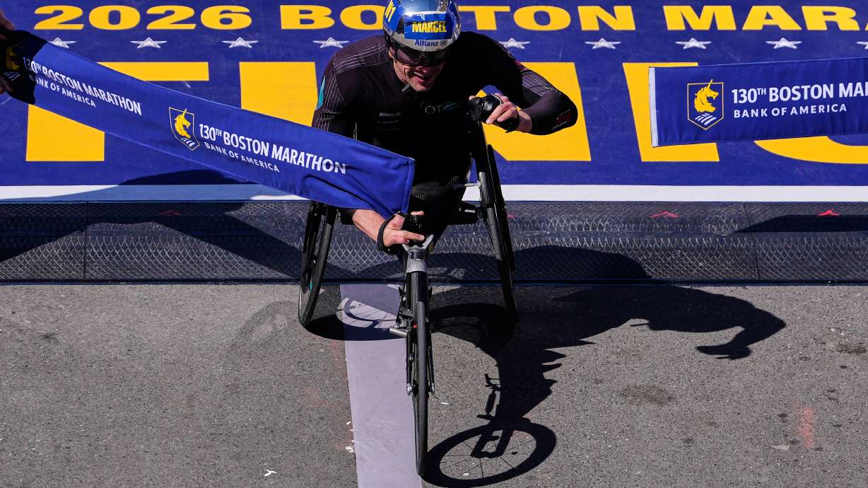 Marcel Hug, of Switzerland, breaks the tape to win the men's wheelchair division at the Boston Marathon, Monday, April 20, 2026, in Boston.
