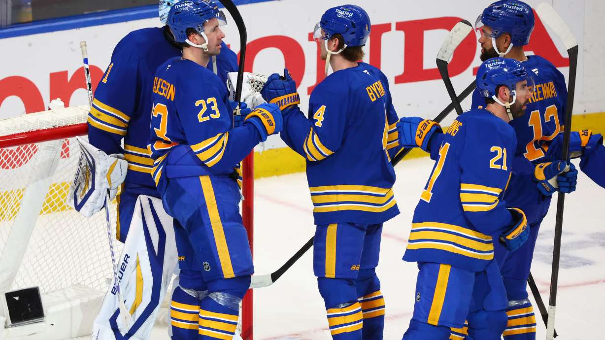 Buffalo Sabres players celebrate victory following the third period in Game 1 of a first-round NHL hockey Stanley Cup playoff series against the Boston Bruins, Sunday, April 19, 2026, in Buffalo, N.Y.