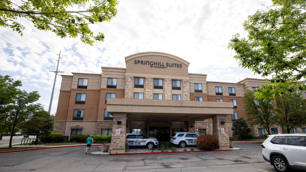 Salt Lake police crime scene investigator vehicles are parked outside of the Springhill Suites at 625 S. 300 West in Salt Lake City following a shooting at the hotel on Monday. Two people have been arrested in Wyoming.