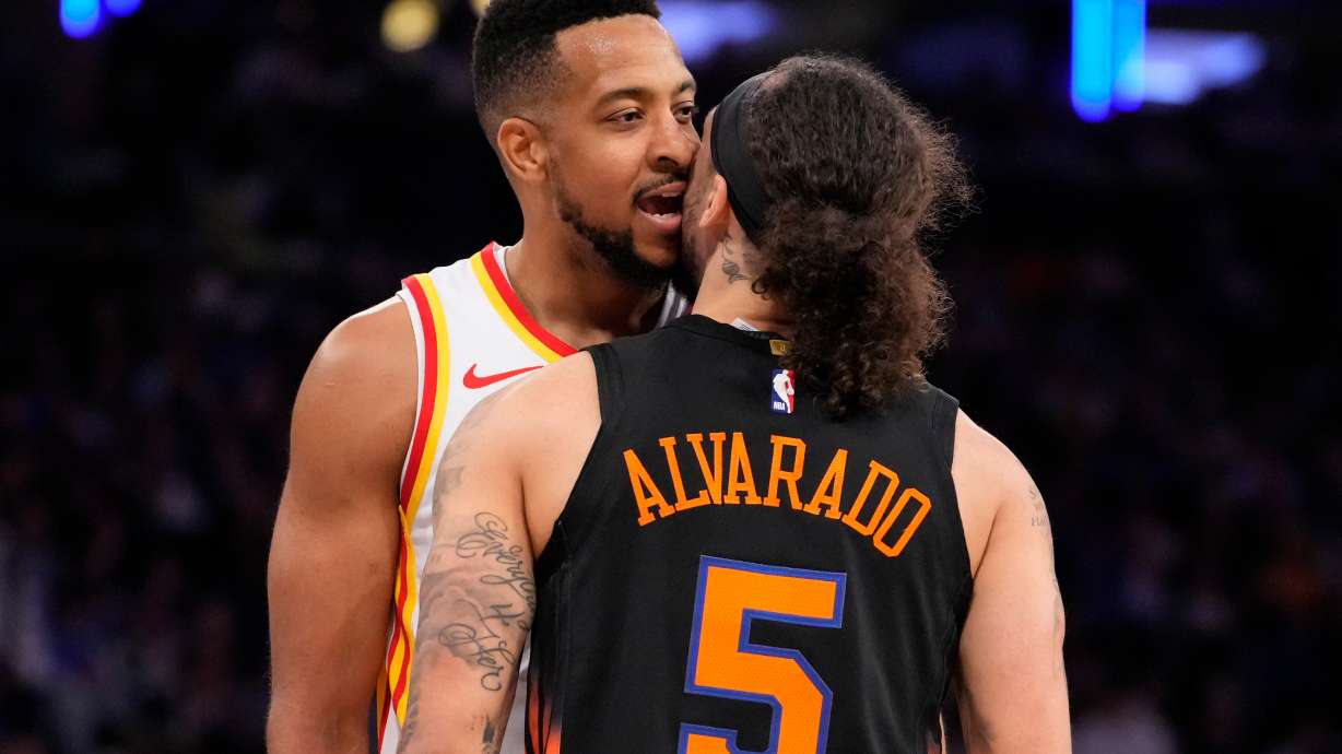 Atlanta Hawks guard CJ McCollum, left, argues with New York Knicks guard Jose Alvarado (5) during the second half in Game 2 of a first-round NBA playoffs basketball series, Monday, April 20, 2026, in New York.