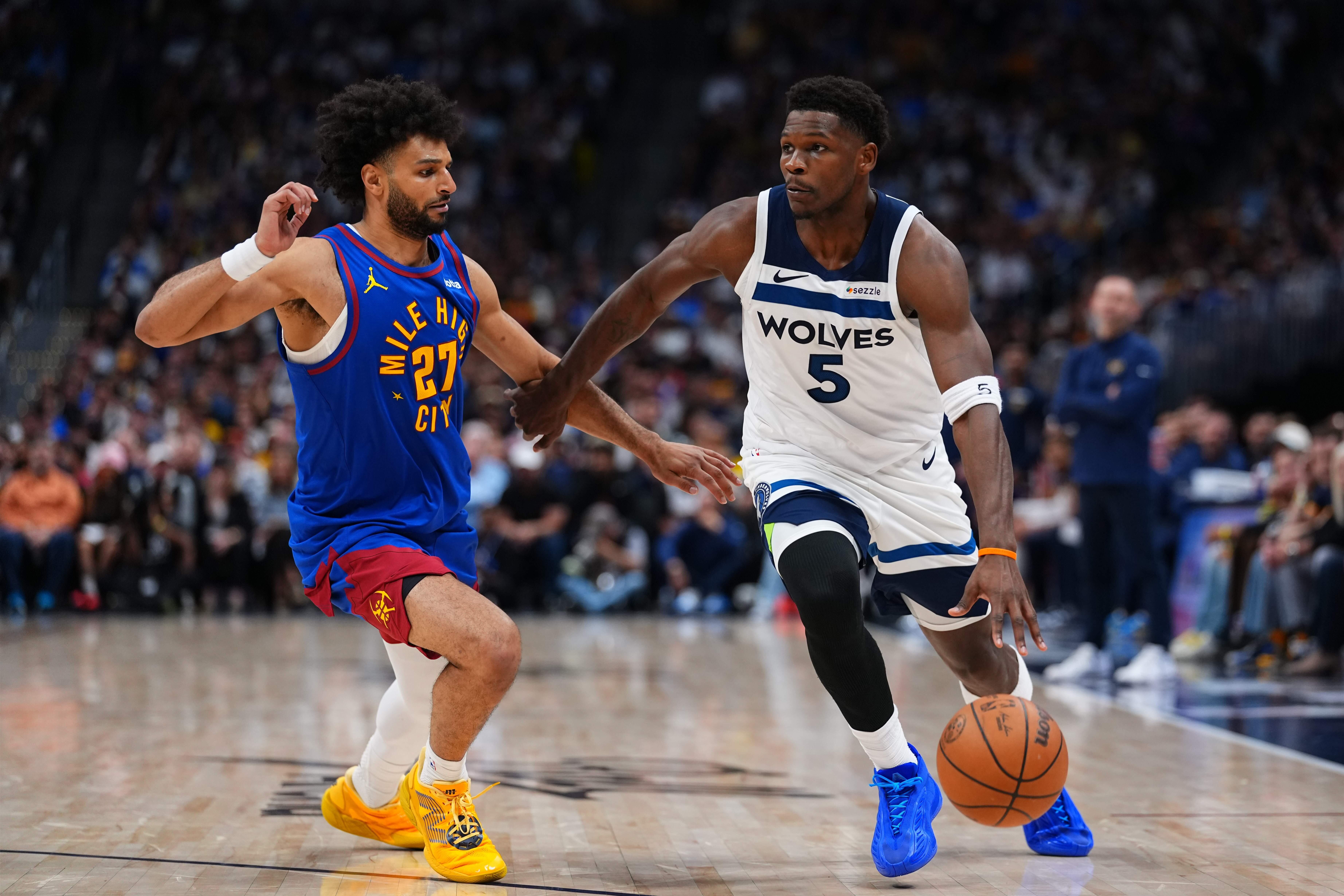 Minnesota Timberwolves guard Anthony Edwards (5) drives to the basket against Denver Nuggets guard Jamal Murray (27) during the second half in Game 2 of a first-round NBA playoffs basketball series Monday, April 20, 2026, in Denver. 