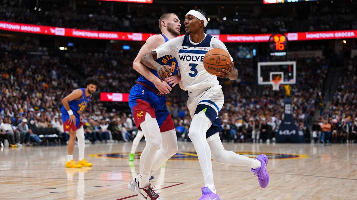 Minnesota Timberwolves Jaden McDaniels (3) drives to the basket against Denver Nuggets guard Christian Braun (0) during the second half in Game 2 of a first-round NBA playoffs basketball series Monday, April 20, 2026, in Denver. CORRECTION Correct to Julius Randle in stead of Julius Randle.