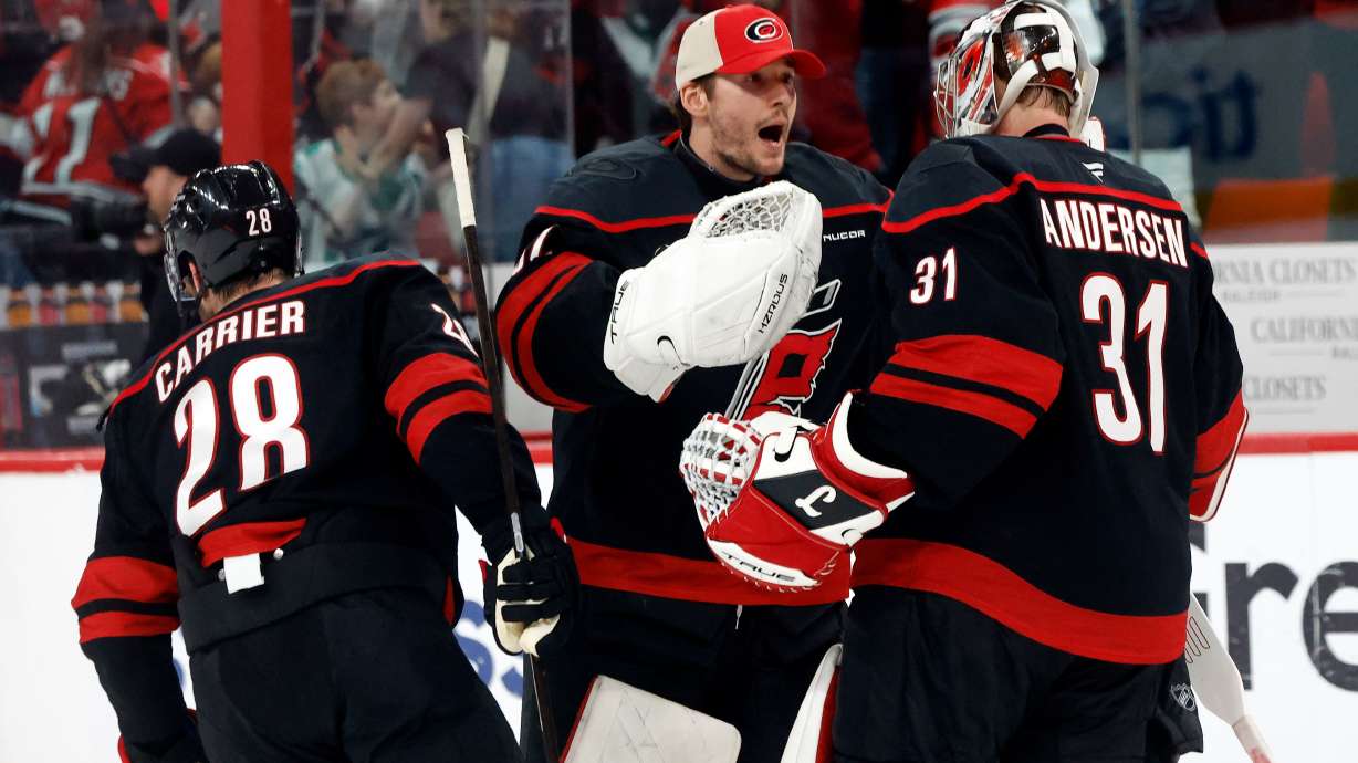 Carolina Hurricanes goaltender Brandon Bussi (32) congratulates goaltender Frederik Andersen (31) with William Carrier (28), following the second overtime of Game 2 of an NHL hockey Stanley Cup first-round playoff series against the Ottawa Senators in Raleigh, N.C., Monday, April 20, 2026.