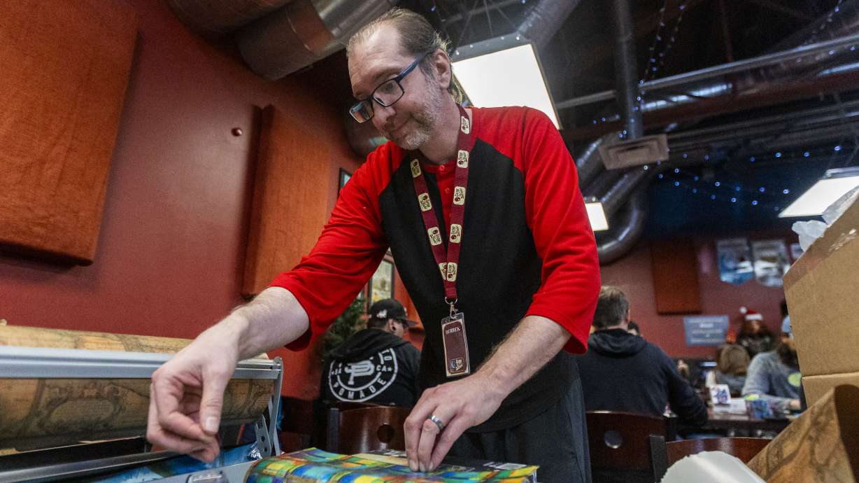 Derrek McNab wraps presents at Game Night Games on Small Business Saturday in Salt Lake City on Nov. 30, 2024. The Qualified Business Income deduction allows Utah small businesses to deduct up to 20% from federal and state taxes.