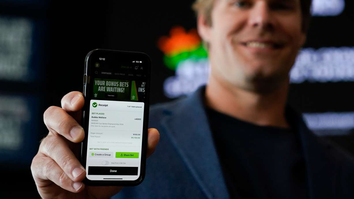 Fox Sports broadcaster Greg Olsen, who placed the first ceremonial bet in North Carolina, shows his receipt during a DraftKings event celebrating the launch of mobile and online sports wagering across the state at the NASCAR Hall of Fame, March 11, 2024, in Charlotte, N.C.