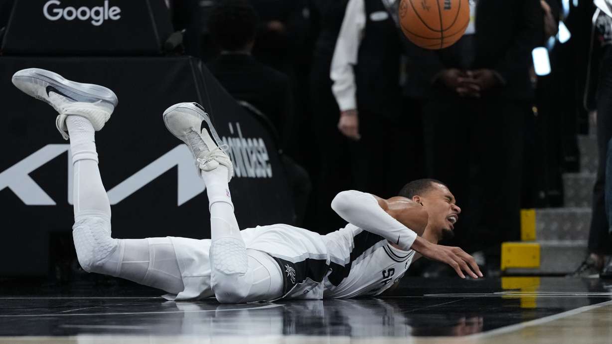 San Antonio Spurs forward Victor Wembanyama (1) takes a hard fall on the court during the first half in Game 2 of a first-round NBA playoffs basketball series against the Portland Trail Blazers in San Antonio, Tuesday, April 21, 2026.