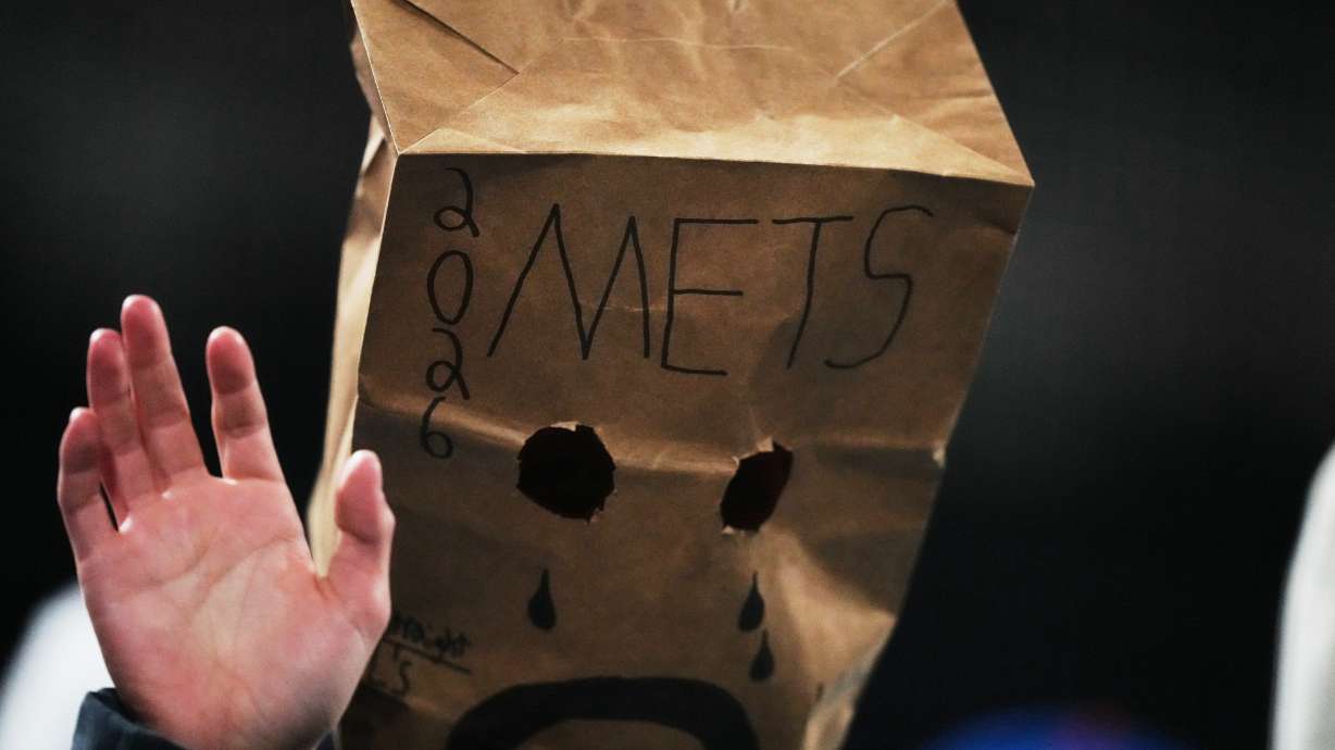A New York Mets fan watches during the eighth inning of a baseball game against the Minnesota Twins Tuesday, April 21, 2026, in New York.