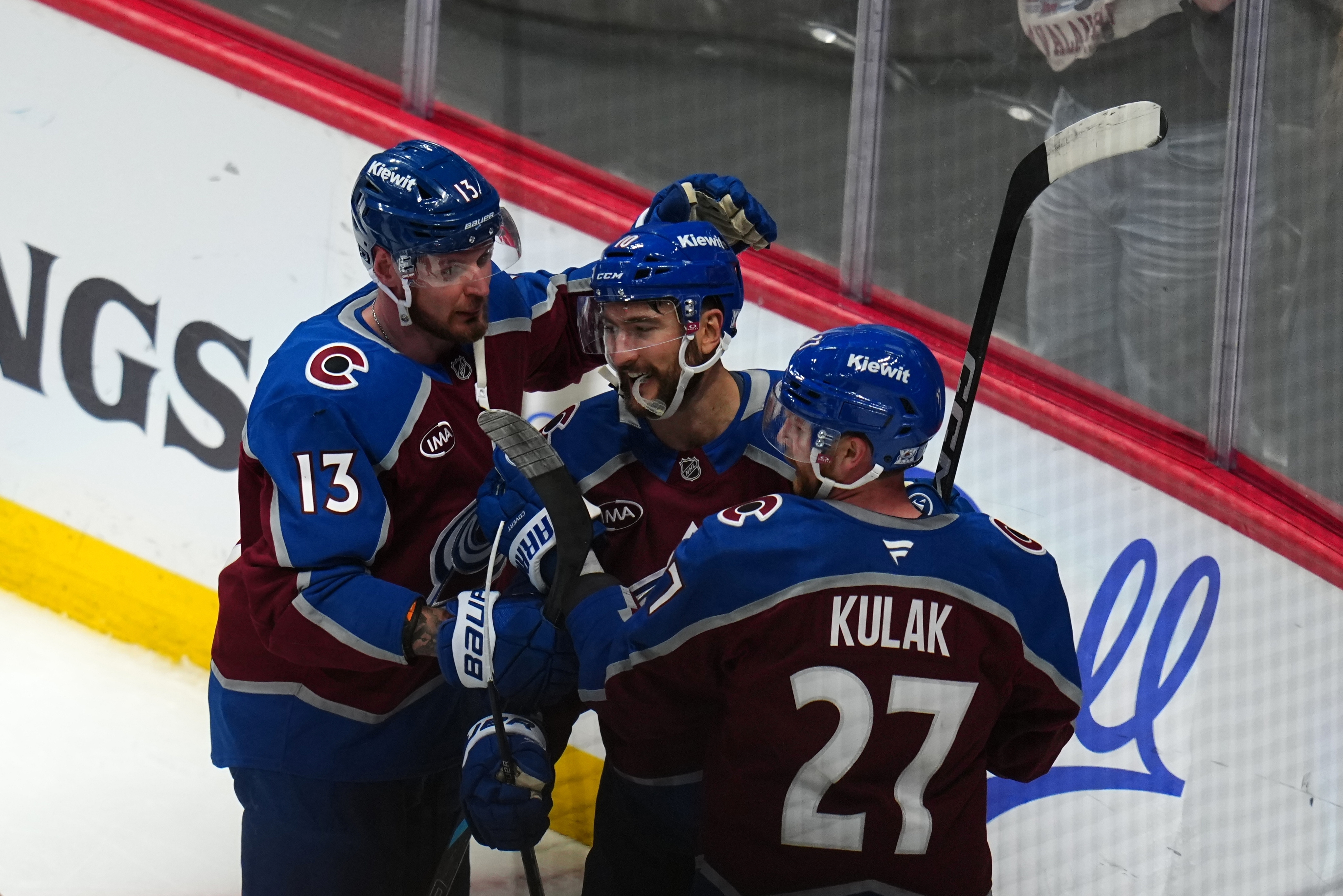 Colorado Avalanche center Nicolas Roy (10) is congratulated by teammates Valeri Nichushkin (13) and Brett Kulak (27) after scoring the game winning goal against the Los Angeles Kings in overtime of Game 2 in the first round of the NHL hockey Stanley Cup playoffs, Tuesday, April 21, 2026, in Denver. 