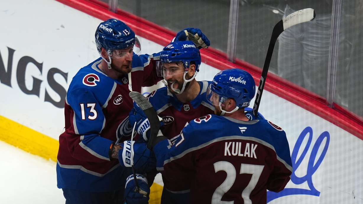 Colorado Avalanche center Nicolas Roy (10) is congratulated by teammates Valeri Nichushkin (13) and Brett Kulak (27) after scoring the game winning goal against the Los Angeles Kings in overtime of Game 2 in the first round of the NHL hockey Stanley Cup playoffs, Tuesday, April 21, 2026, in Denver.