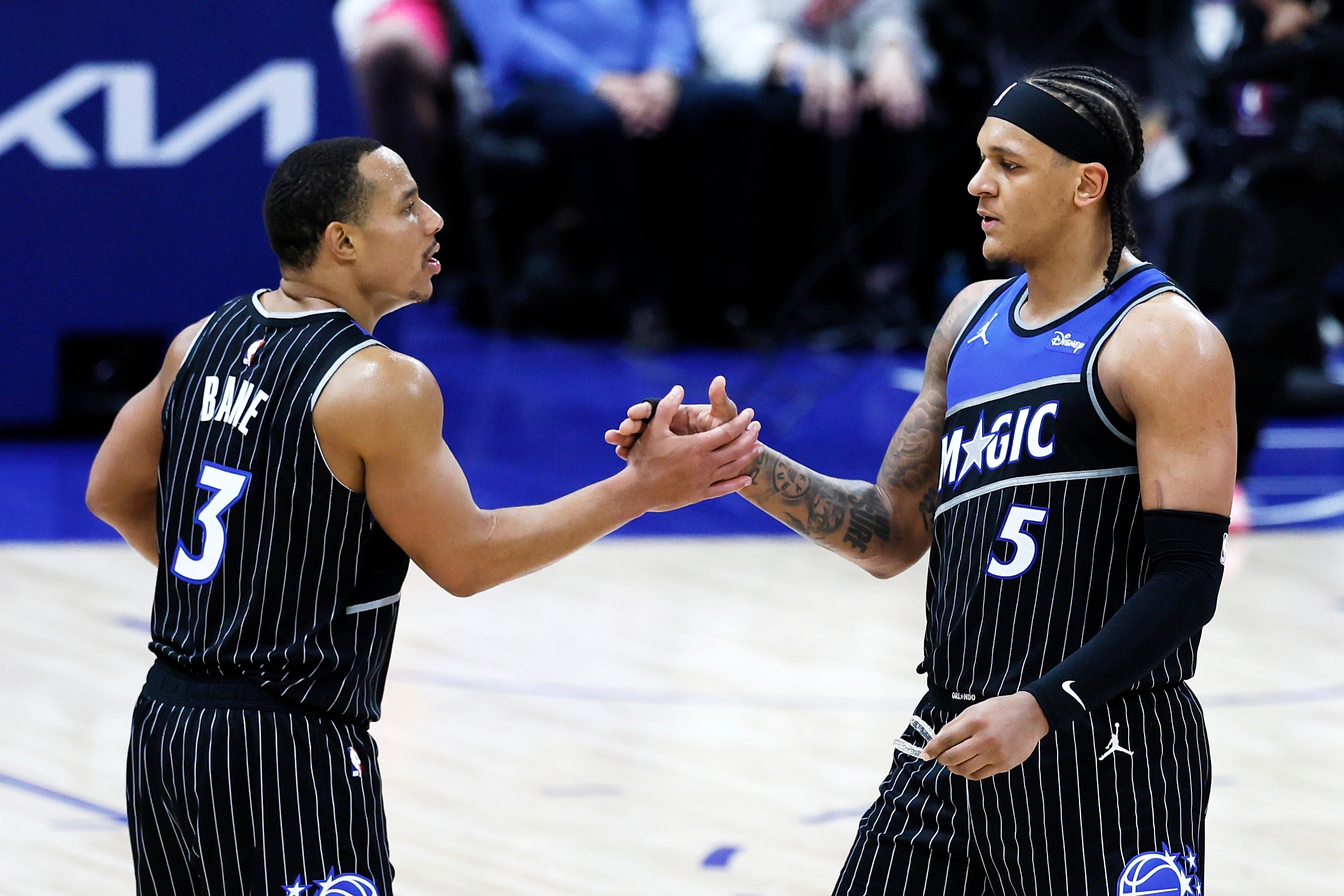 Orlando Magic guard Desmond Bane (3) celebrates with forward Paolo Banchero (5) after a win over the Detroit Pistons in Game 1 of a first-round NBA basketball playoffs series Sunday, April 19, 2026, in Detroit. 