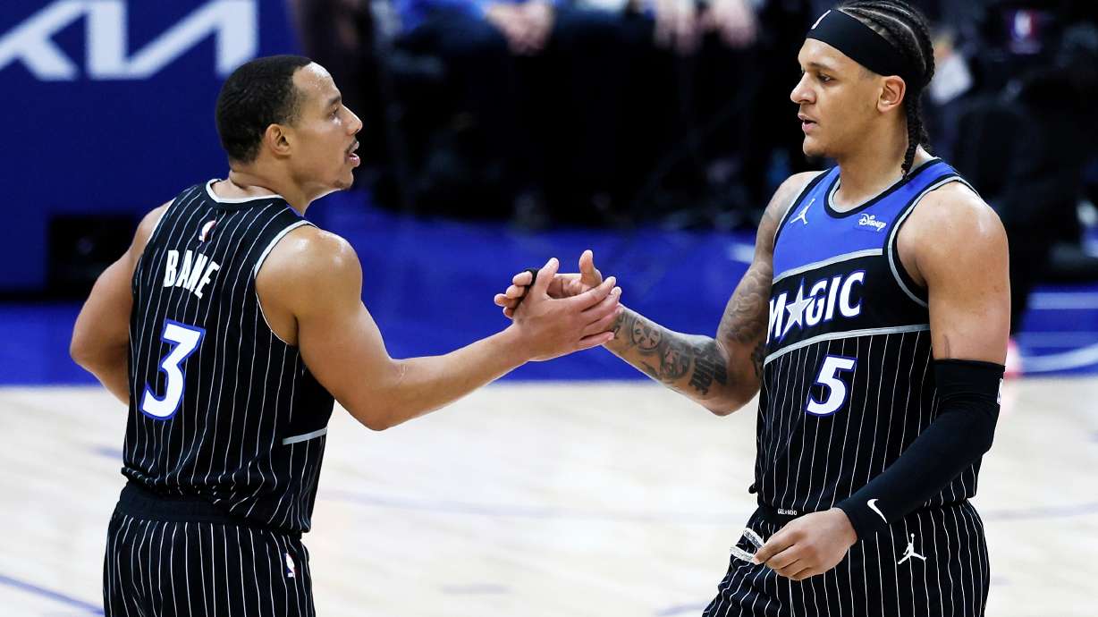 Orlando Magic guard Desmond Bane (3) celebrates with forward Paolo Banchero (5) after a win over the Detroit Pistons in Game 1 of a first-round NBA basketball playoffs series Sunday, April 19, 2026, in Detroit.