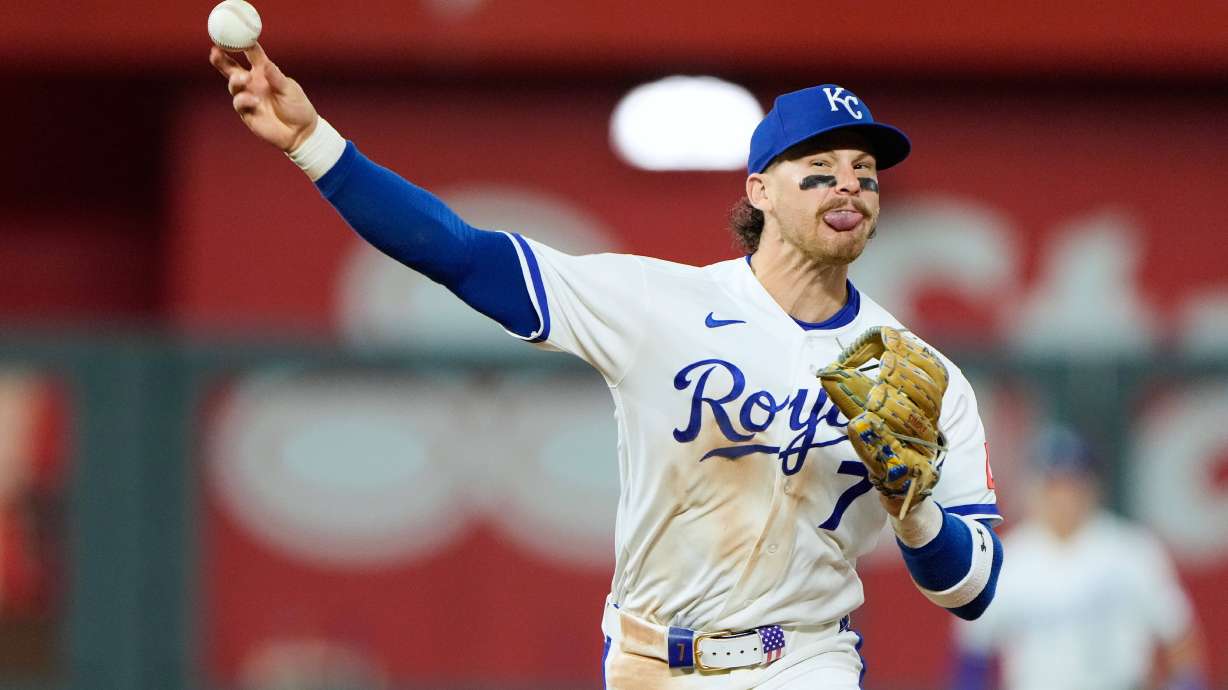 Kansas City Royals shortstop Bobby Witt Jr. throws to first for the double play hit into by Baltimore Orioles' Colton Cowser during the ninth inning of a baseball game Tuesday, April 21, 2026, in Kansas City, Mo.