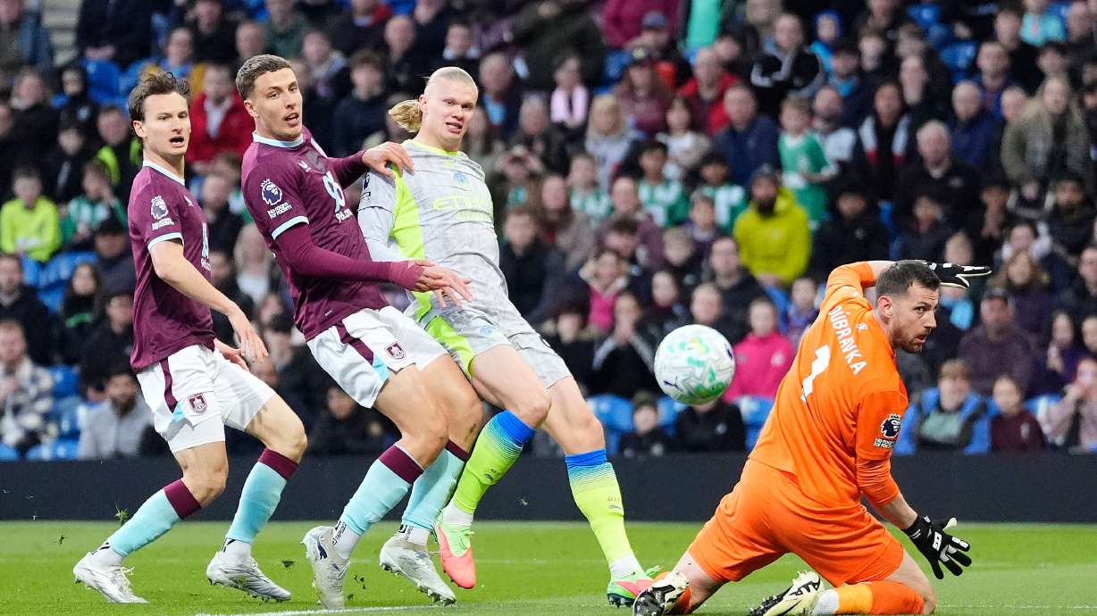 Manchester City's Erling Haaland, second right, scores his side's opening goal during the Premier League soccer match between Burnley and Manchester City in Burnley, England, Wednesday, April 22, 2026.