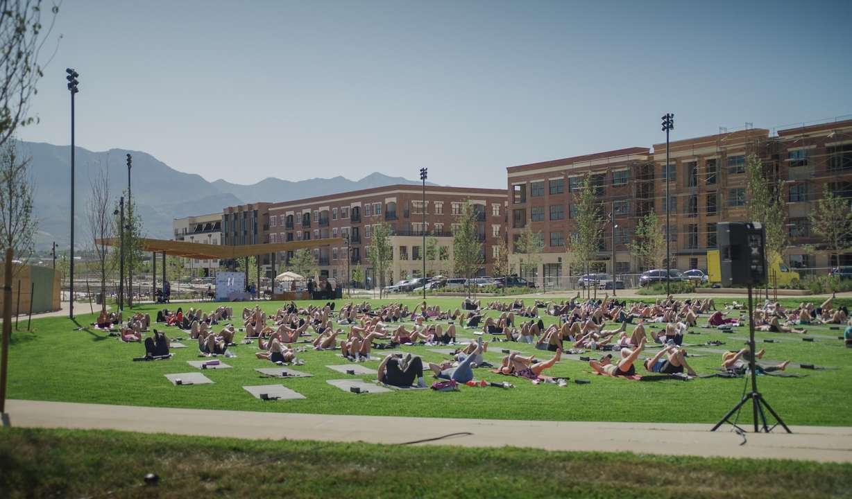 People participate in an outdoor workout class at Civic Park in Utah City, a community in Vineyard.