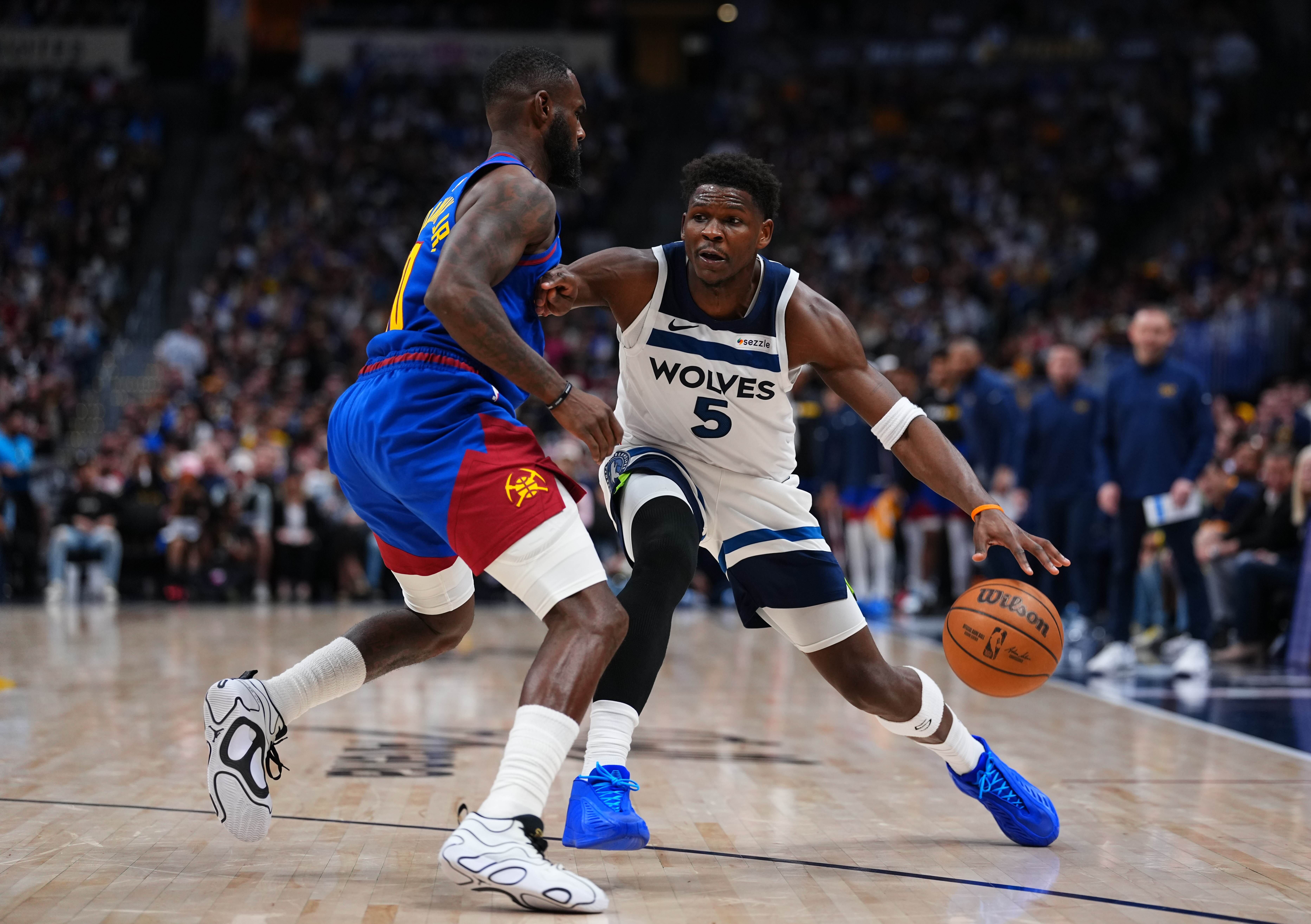 Minnesota Timberwolves guard Anthony Edwards (5) drives to the basket against Denver Nuggets guard Tim Hardaway Jr. (10) during the second half in Game 2 of a first-round NBA playoffs basketball series Monday, April 20, 2026, in Denver. 