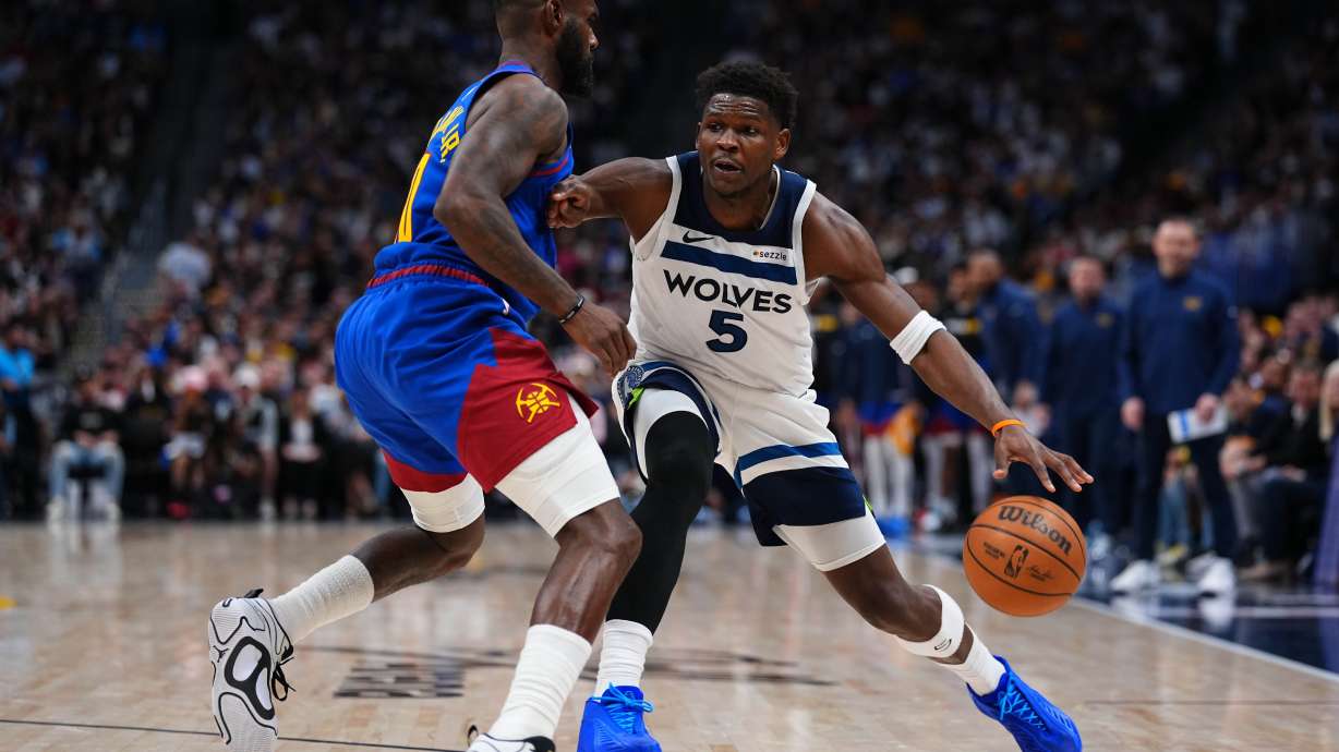 Minnesota Timberwolves guard Anthony Edwards (5) drives to the basket against Denver Nuggets guard Tim Hardaway Jr. (10) during the second half in Game 2 of a first-round NBA playoffs basketball series Monday, April 20, 2026, in Denver.