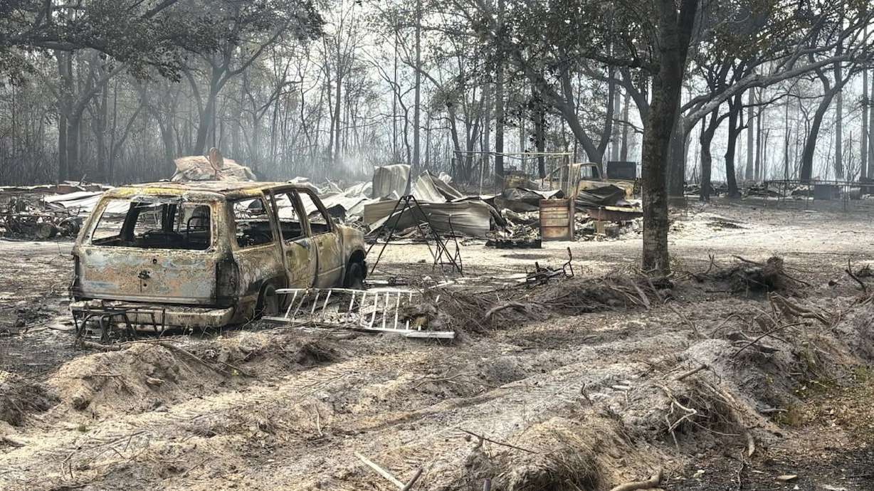 This photo provided by the Georgia Department of Natural Resources shows burned vehicles and trees from the Pineland Road Fire in southeast Georgia on Wednesday, April 22, 2026.
