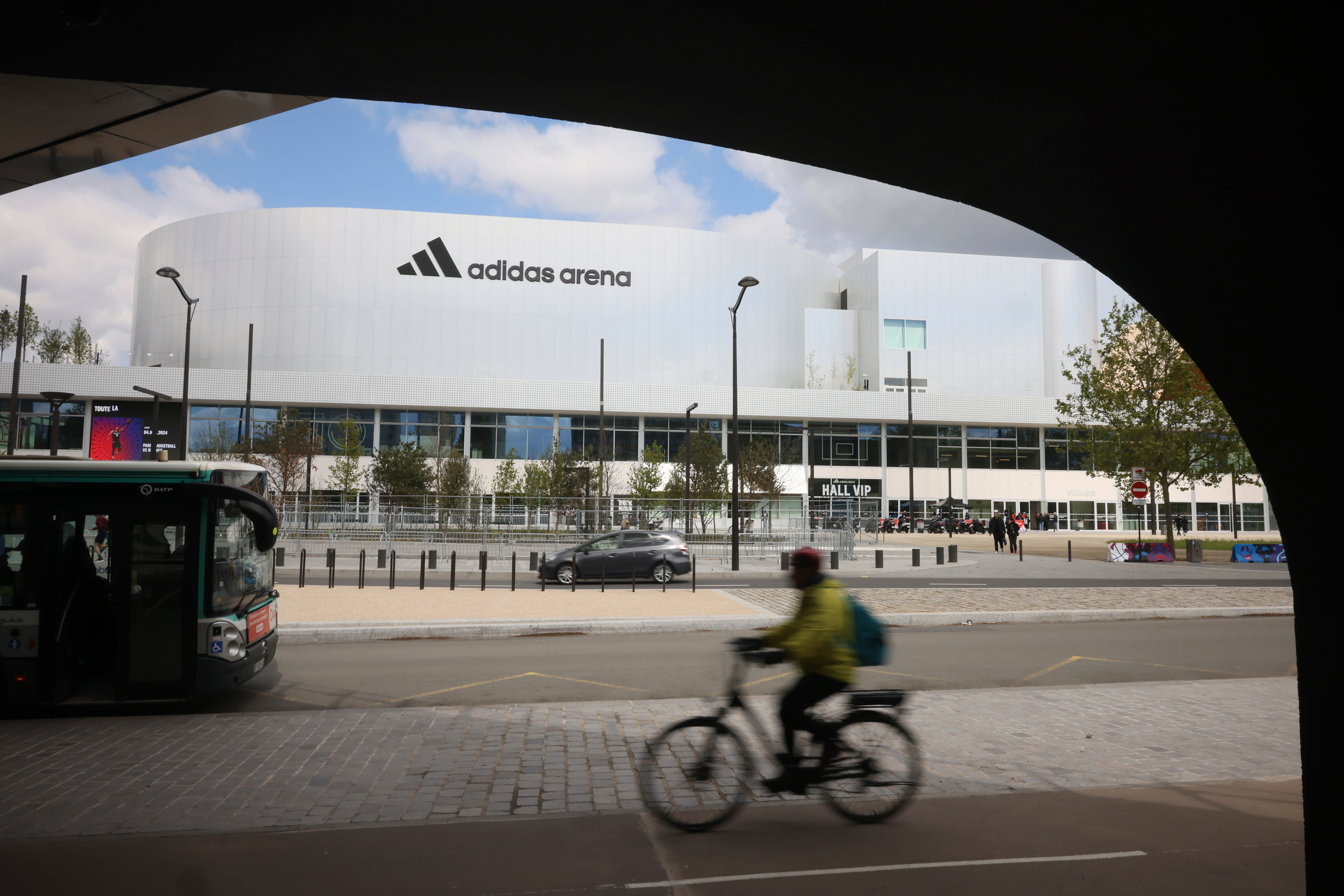 FILE - A cyclist rides past the Adidas Arena, April 18, 2024, in Paris, France. 