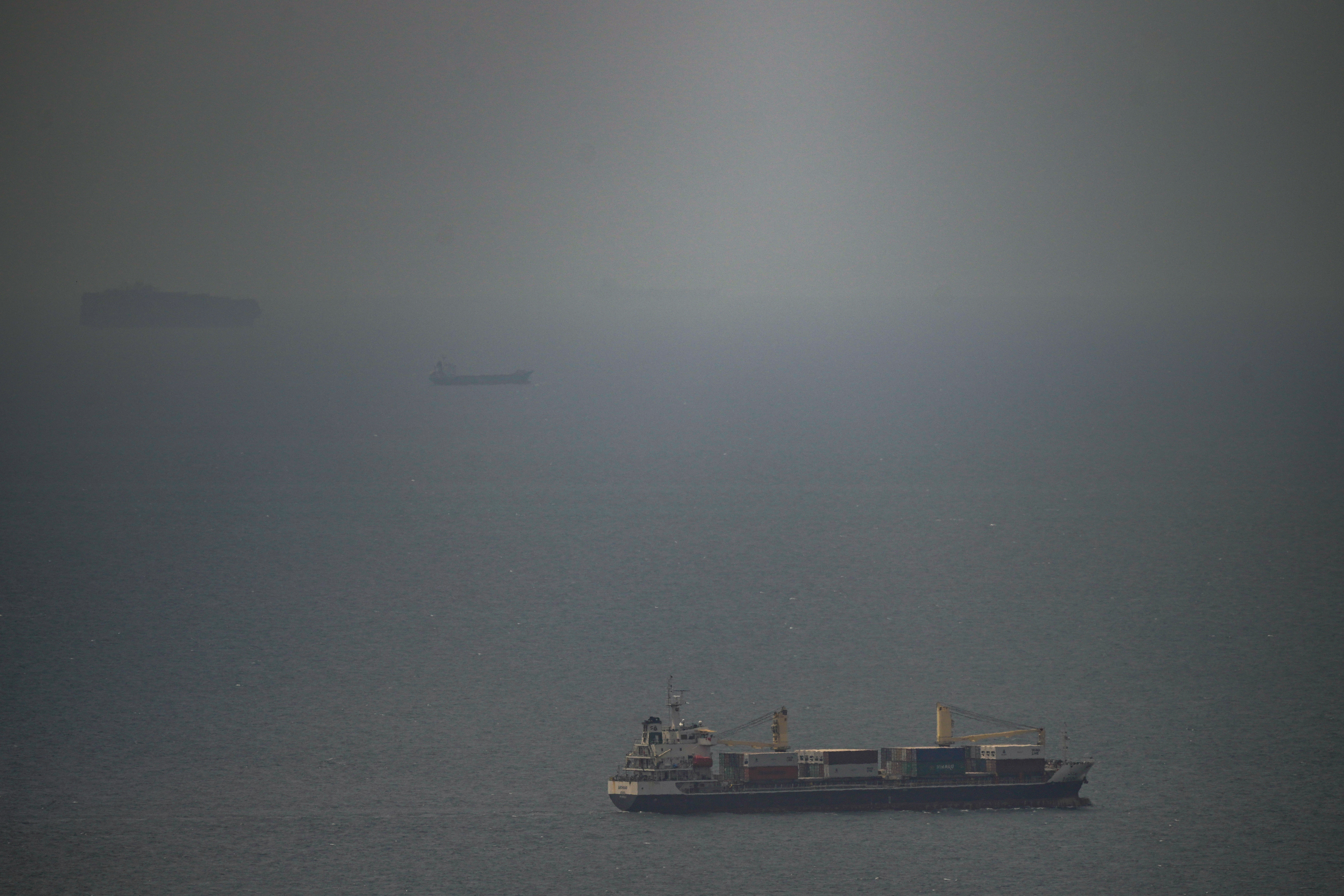 A cargo ship sails in the Persian Gulf toward the Strait of Hormuz, Wednesday. Safety concerns are rising a day after Iran seized three cargo ships in the strait.