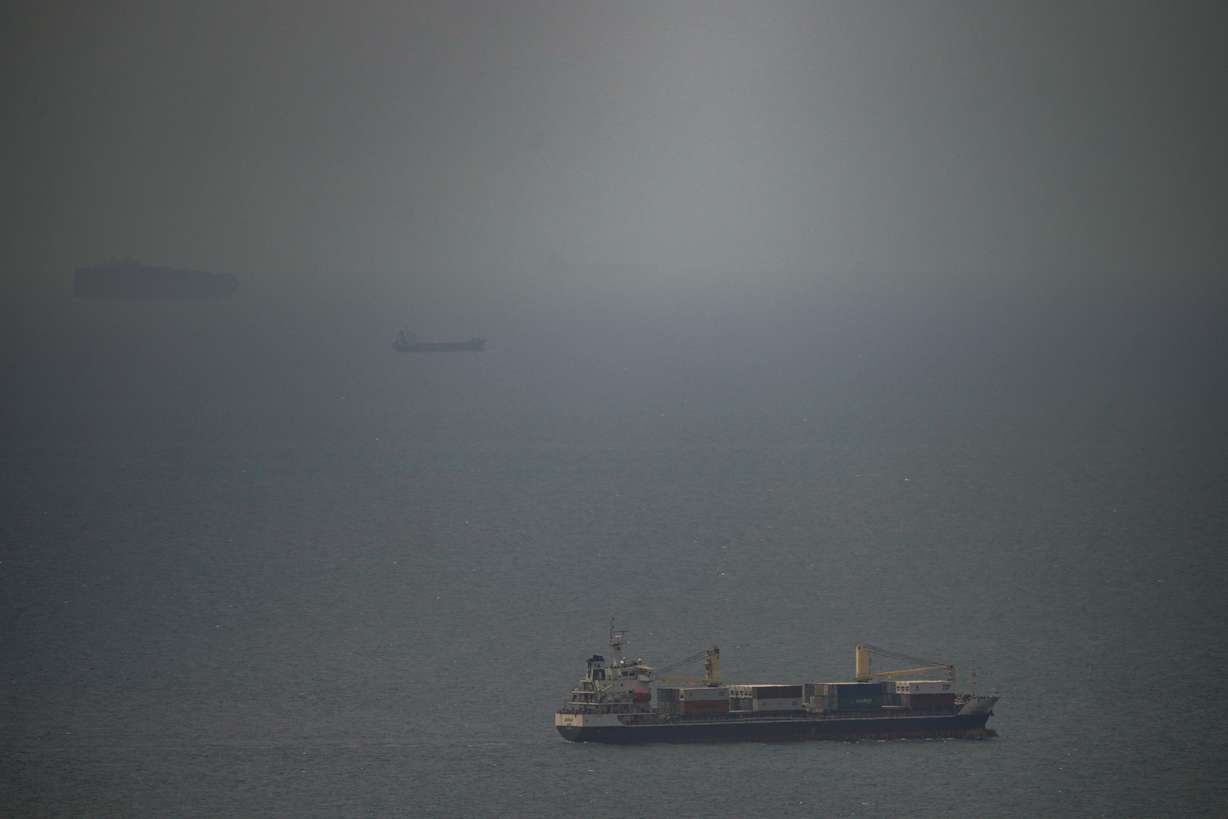 A cargo ship sails in the Persian Gulf toward the Strait of Hormuz, Wednesday. Safety concerns are rising a day after Iran seized three cargo ships in the strait.