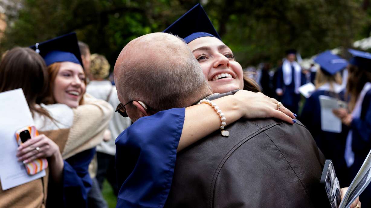 Hannah Hutchinson hugs her father after graduating with a bachelor's degree from BYU in Provo on Thursday. President Shane Reese reported a record 91% of graduates said their time at BYU strengthened their faith in Jesus Christ.