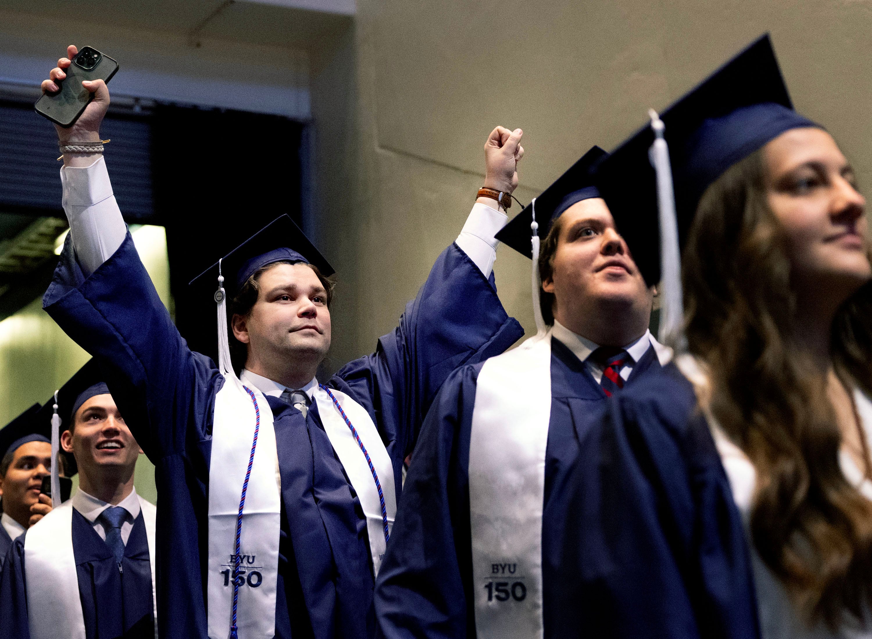 Cameron Benson celebrates as he enters the Marriott Center for BYU commencement in Provo on Thursday. President Shane Reese said the graduates "built on the sure foundation of Jesus Christ" during their time at the school.