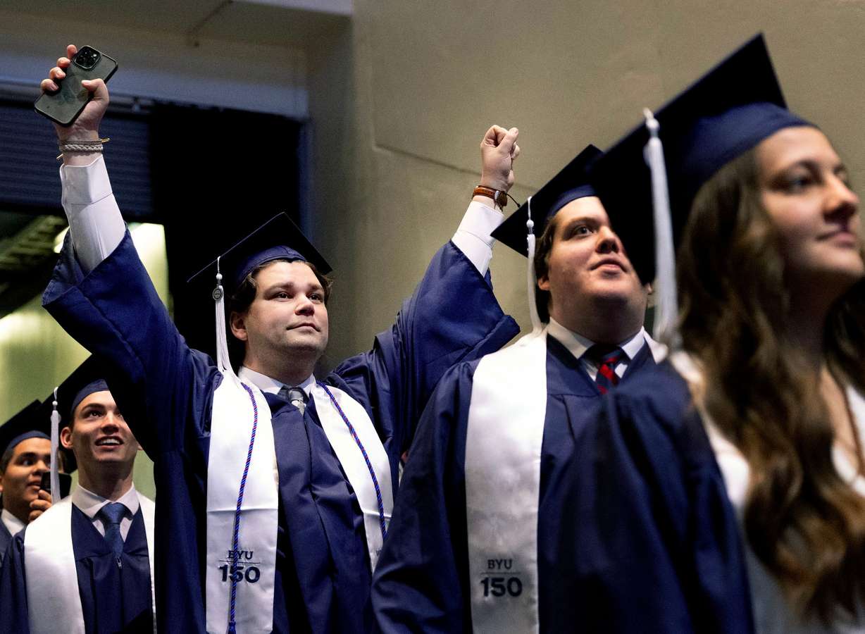 Cameron Benson celebrates as he enters the Marriott Center for BYU commencement in Provo on Thursday. President Shane Reese said the graduates "built on the sure foundation of Jesus Christ" during their time at the school.