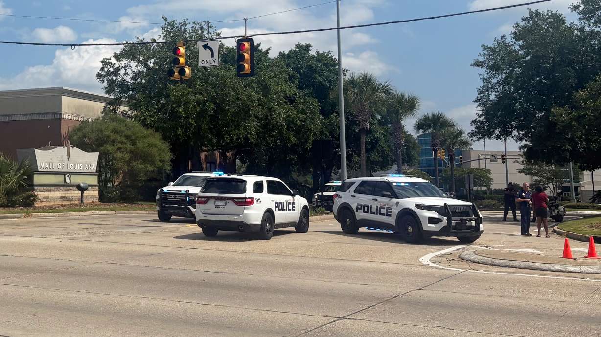Law enforcement personnel respond to reports of a shooting at Mall of Louisiana in Baton Rouge, La., Thursday. The shooting, described by police as a confrontation between two groups, left one person dead and five more wounded.