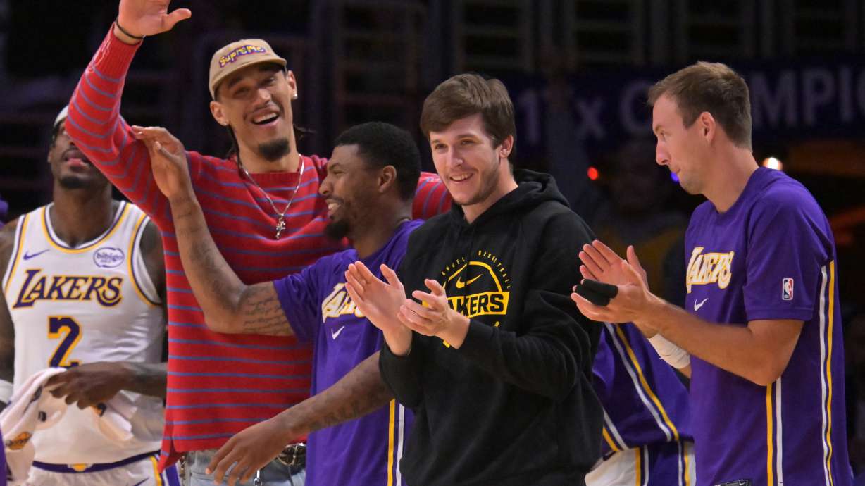 Los Angeles Lakers center Jaxson Hayes, left, Lakers' guard Marcus Smart (36), Lakers' guard Austin Reaves and guard Luke Kennard, right, react after a three-point basket by Lakers' forward Dalton Knecht (4) during the second half of an NBA basketball game against the Utah Jazz, April 12, 2026, in Los Angeles.