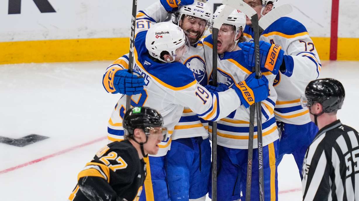 Buffalo Sabres right wing Alex Tuch (89) celebrates his goal with teammates as Boston Bruins defenseman Hampus Lindholm (27) skates past during the third period in Game 3 of a first-round NHL hockey Stanley Cup playoff series, Thursday, April 23, 2026, in Boston.