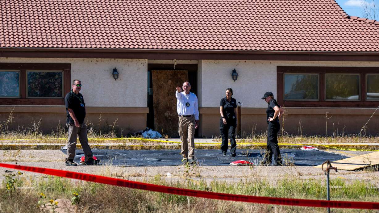 Fremont County coroner Randy Keller and other authorities survey the area at the Return to Nature Funeral Home, Oct. 7, 2023, in Penrose, Colo. The former owner of the funeral home was sentenced to 30 years in prison on Friday.