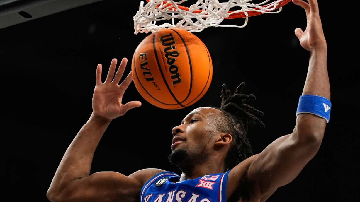 FILE - Kansas' Darryn Peterson dunks during the first half of an NCAA college basketball game against Houston in the semifinal round of the Big 12 Conference tournament March 13, 2026, in Kansas City, Mo.