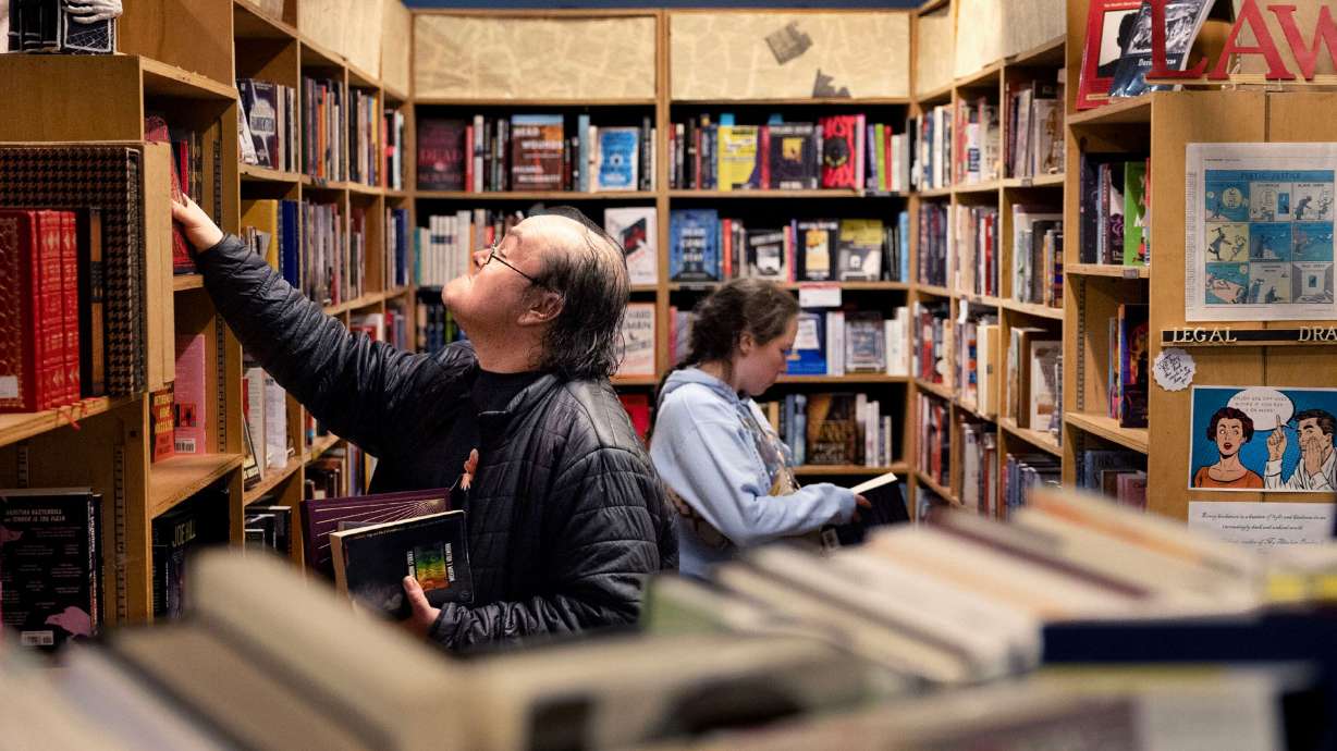 Kadath Lopez, left, and Victoria Zimmer browse for books at Weller Book Works in Salt Lake City on Wednesday.