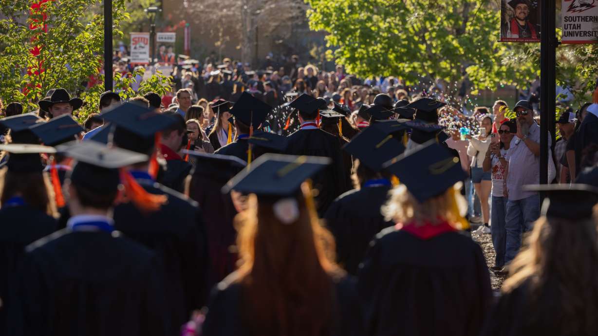 Graduates make their way to graduation festivities ahead of Southern Utah University's 127th annual commencement ceremony.