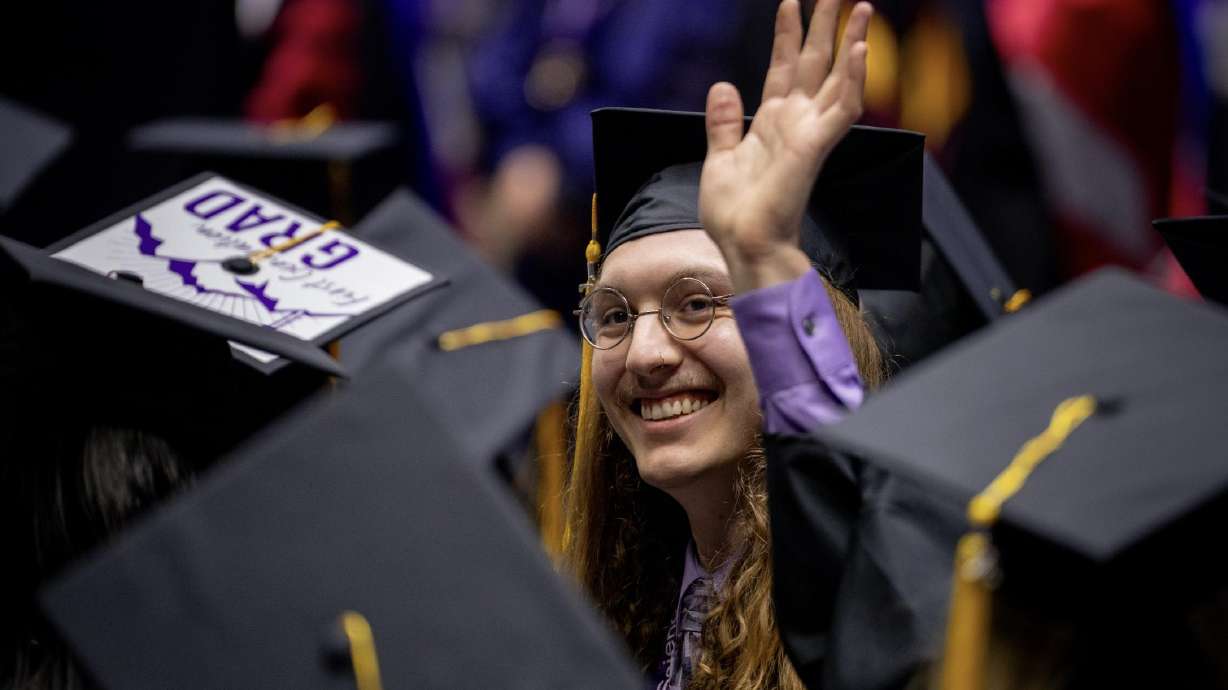 Graduates celebrate during Weber State University's spring 2026 commencement at Dee Events Center on Friday.