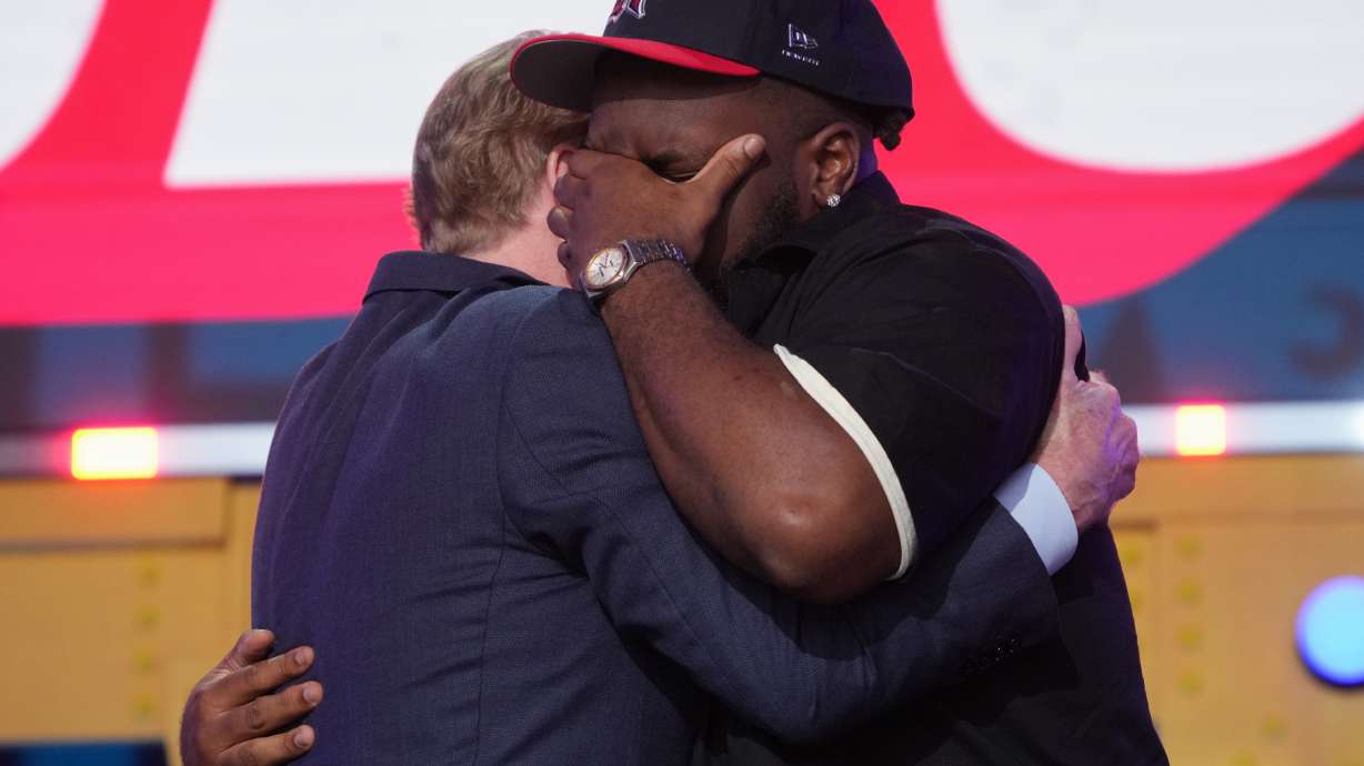 Ohio State defensive lineman Kayden McDonald, right, reacts with NFL Commissioner Roger Goodell after being chosen by the Houston Texans with the 36th overall pick during the second round of the NFL football draft, Friday, April 24, 2026, in Pittsburgh.