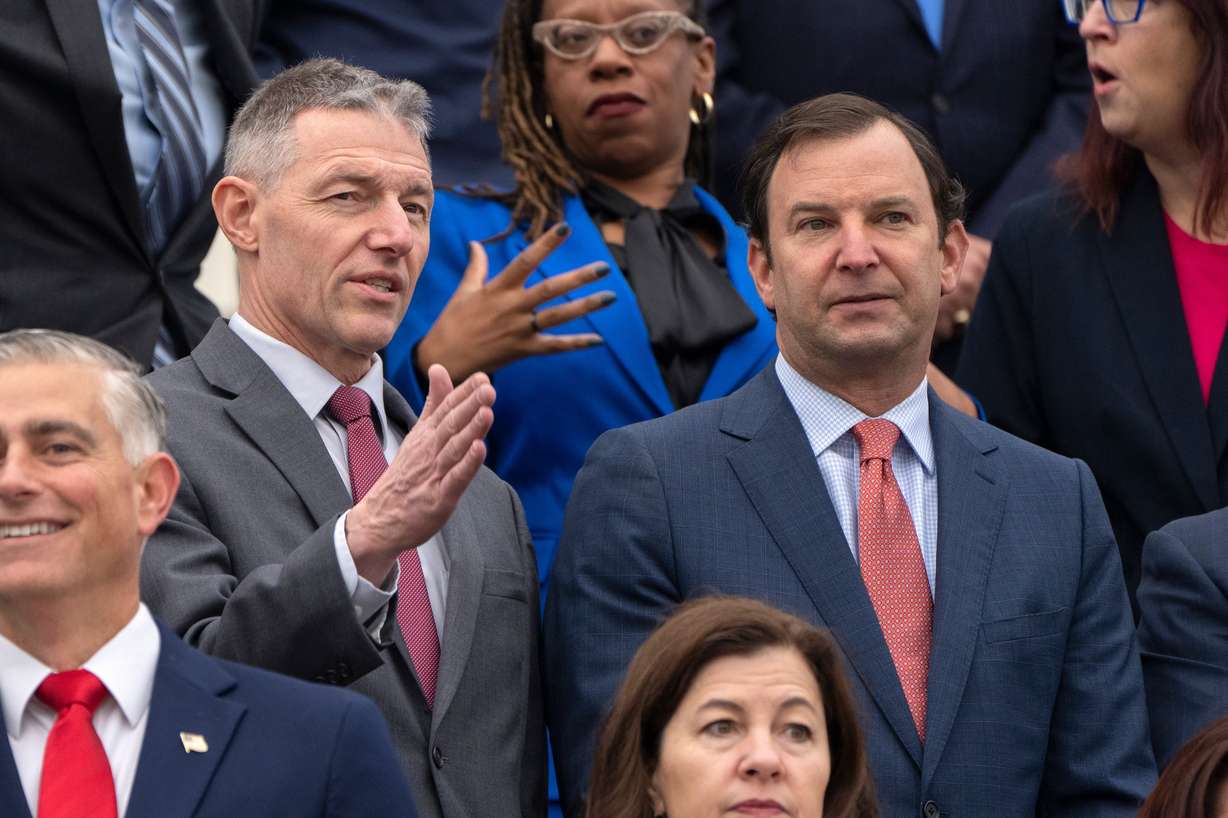 Rep.-elect Mike Kennedy, R-Utah, left, talks with Rep.-elect Craig Goldman, R-Texas, as newly-elected House members gather for a freshman class photo on the Capitol steps, in Washington, Nov. 15, 2024.