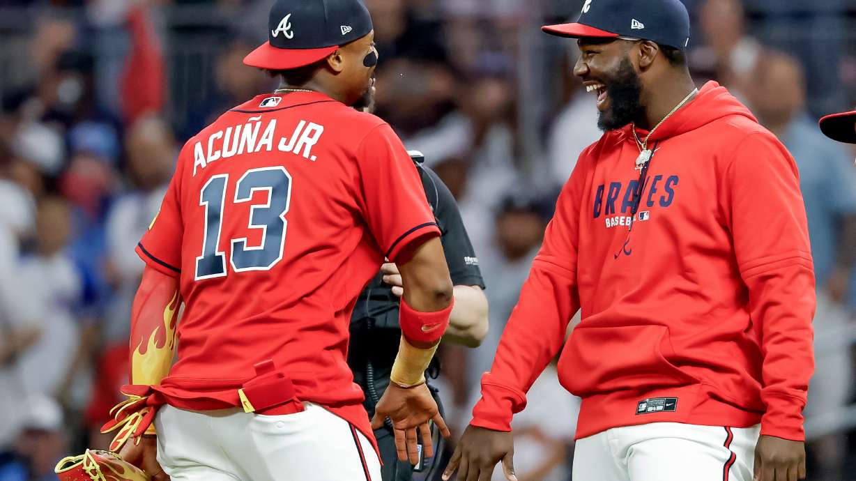 Atlanta Braves' Ronald Acuna Jr. (13) and Michael Harris II, right, celebrate after their team defeated the Philadelphia Phillies in a baseball game, Friday, April 24, 2026, in Atlanta.