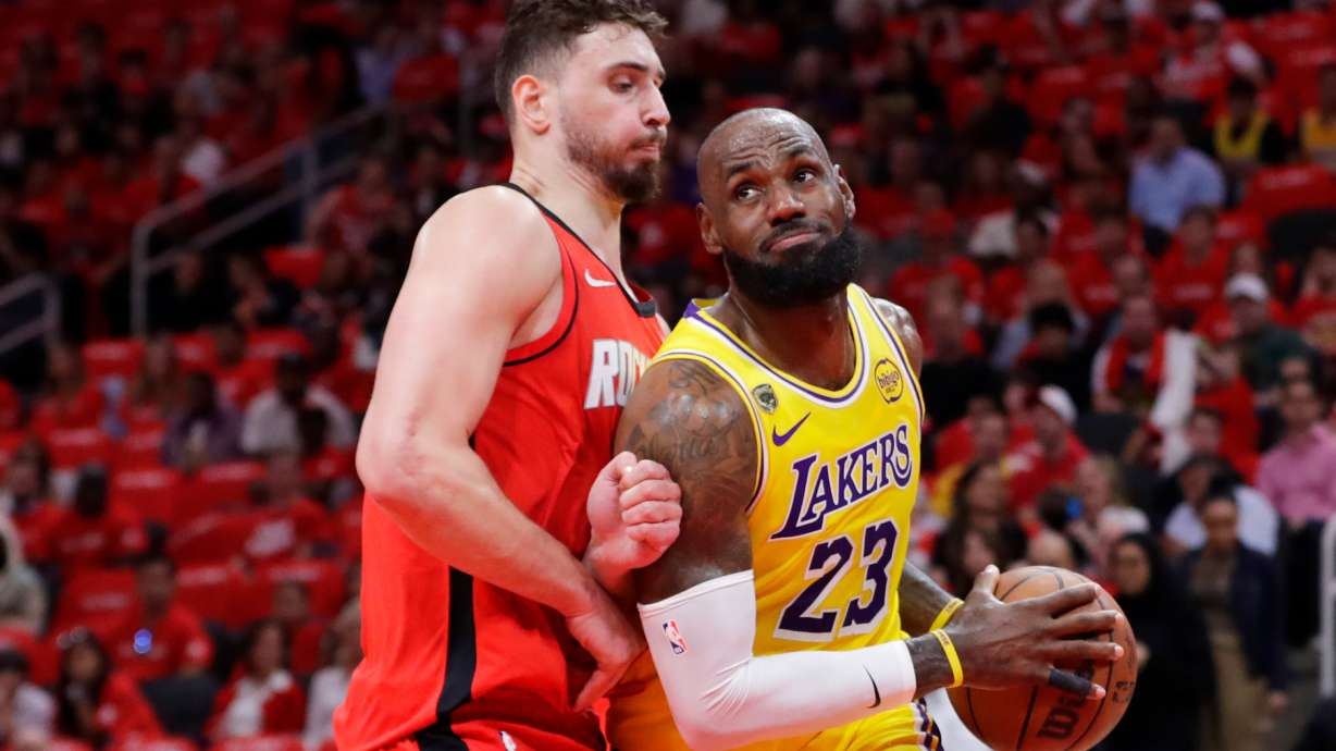 Los Angeles Lakers forward LeBron James (23) drives to the basket in front of Houston Rockets center Alperen Sengun, left, during the first half of Game 3 in a first-round NBA playoffs basketball series Friday April 24, 2026, in Houston.