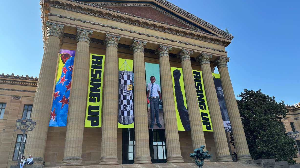 Banners for the "Rising Up: Rocky" exhibition hang outside of the Philadelphia Museum of Art in Philadelphia, Wednesday. After decades of distancing itself from the fictional boxer, the museum is embracing it.