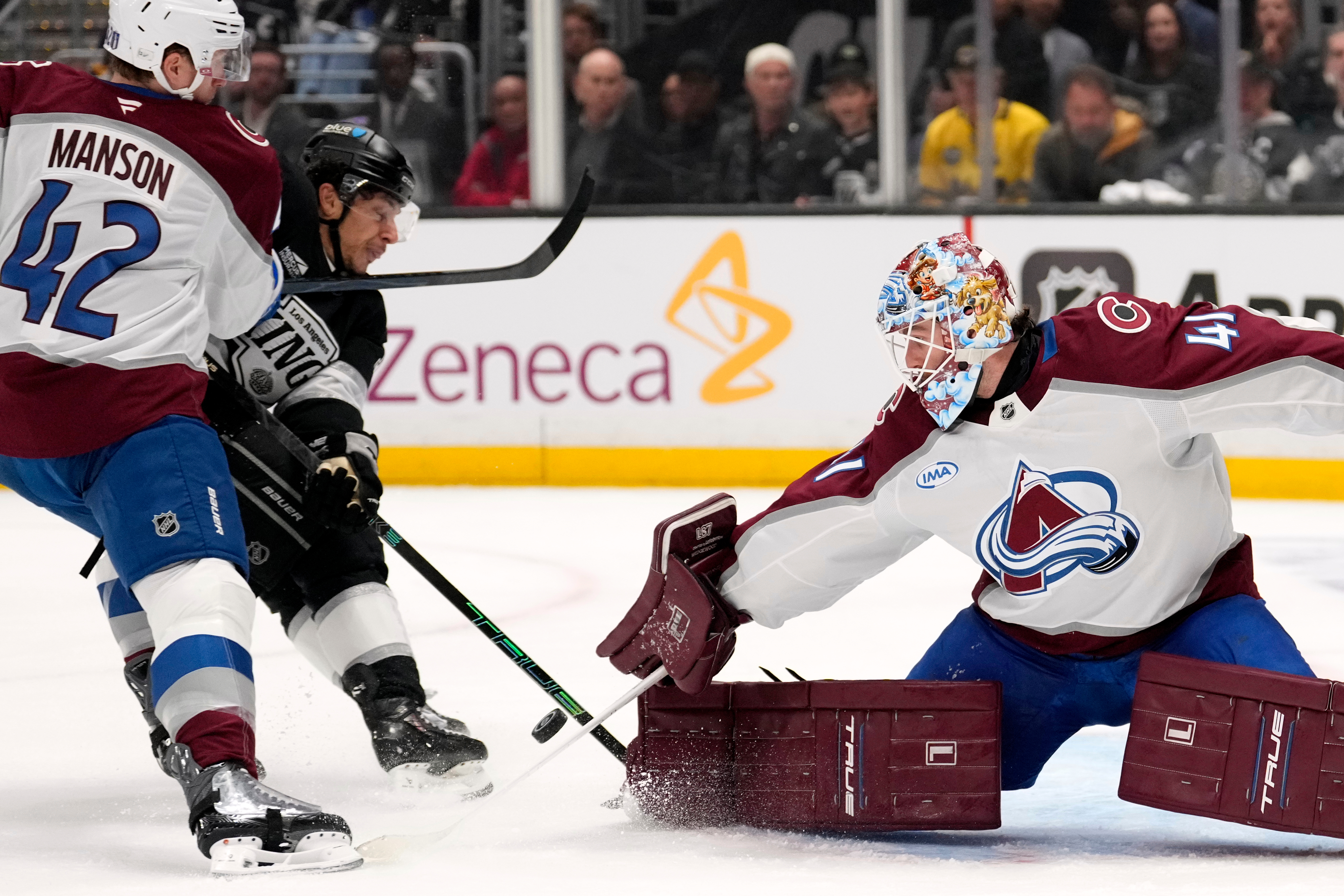 Los Angeles Kings left wing Trevor Moore, center, scores on goaltender Scott Wedgewood, right, as defenseman Josh Manson defends during the second period of Game 3 in the first round of the NHL hockey Stanley Cup playoffs Thursday, April 23, 2026, in Los Angeles. 